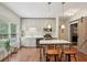 Bright kitchen includes shaker cabinets, stainless steel appliances, and island with seating at 3235 Munsey Ct, Cumming, GA 30041