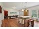 Bright eat-in kitchen with wood floors, island with stools, and stainless steel appliances at 3235 Munsey Ct, Cumming, GA 30041