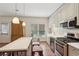 Bright kitchen boasts stainless steel appliances, center island with seating, and lots of cabinet space at 3235 Munsey Ct, Cumming, GA 30041