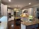 Spacious kitchen features granite countertops, stainless appliances, and a central island, ideal for cooking and entertaining at 3235 Munsey Ct, Cumming, GA 30041