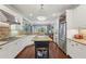 This open concept kitchen boasts stainless steel appliances, granite counters, island, and ample storage at 3235 Munsey Ct, Cumming, GA 30041