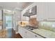 Well-equipped kitchen with gas cooktop, granite counters, and stainless steel hood vent at 3235 Munsey Ct, Cumming, GA 30041