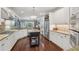This open concept kitchen boasts stainless steel appliances, granite counters, island, and ample storage at 3235 Munsey Ct, Cumming, GA 30041