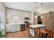 Well-equipped kitchenette featuring stainless steel appliances, a marble island with seating, and a rustic barn door at 3235 Munsey Ct, Cumming, GA 30041