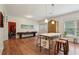 Spacious kitchenette area featuring barstool seating at a marble island and hardwood floors throughout at 3235 Munsey Ct, Cumming, GA 30041