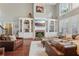 Spacious living room with fireplace, built-in shelves, hardwood floors, and large windows for natural light at 3235 Munsey Ct, Cumming, GA 30041