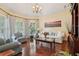 Bright living room with hardwood floors, neutral paint, stylish furnishings, and large windows at 3235 Munsey Ct, Cumming, GA 30041