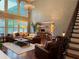 Spacious living room with high ceilings, large windows, and comfortable seating at 3235 Munsey Ct, Cumming, GA 30041