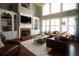 Bright living room with a fireplace, large windows, and hardwood floors at 3235 Munsey Ct, Cumming, GA 30041