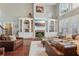 Inviting living room showcases a fireplace with built-ins, large windows, and comfortable leather seating at 3235 Munsey Ct, Cumming, GA 30041