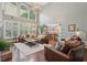 Living room with high ceilings, hardwood floors and stylish brown leather furniture at 3235 Munsey Ct, Cumming, GA 30041