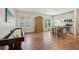 Open-concept living room boasts hardwood floors and island with seating, filled with natural light at 3235 Munsey Ct, Cumming, GA 30041