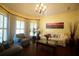 Comfortable and bright living room features hardwood floors, a ceiling fan, and natural light from the large windows at 3235 Munsey Ct, Cumming, GA 30041