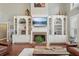 Bright living room with custom built-ins, fireplace, and large windows offering plenty of natural light at 3235 Munsey Ct, Cumming, GA 30041