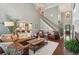 Living room with hardwood floors and views into the kitchen at 3235 Munsey Ct, Cumming, GA 30041