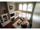 Inviting living room with soaring ceilings, large windows, and a cozy fireplace at 3235 Munsey Ct, Cumming, GA 30041