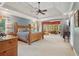 Spacious main bedroom with tray ceilings, large windows, and an adjoining seating area at 3235 Munsey Ct, Cumming, GA 30041