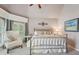 Bedroom with plush chair, neutral decor, large windows and ceiling fan at 3235 Munsey Ct, Cumming, GA 30041