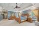 Large primary bedroom suite with tray ceilings, sitting area, and neutral carpet at 3235 Munsey Ct, Cumming, GA 30041