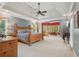 Spacious main bedroom suite with sitting area, tray ceilings, and ample natural light at 3235 Munsey Ct, Cumming, GA 30041