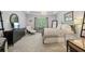 A well-appointed main bedroom boasts a sitting area, dresser, and a large window at 3235 Munsey Ct, Cumming, GA 30041