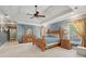 Spacious primary bedroom with tray ceiling, carpet, and wooden furniture at 3235 Munsey Ct, Cumming, GA 30041