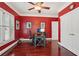 Office space with red walls, hardwood flooring, and a large window with plantation shutters at 3235 Munsey Ct, Cumming, GA 30041