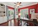 Stylish home office with built-in bookshelves, French doors, a ceiling fan, and a large desk at 3235 Munsey Ct, Cumming, GA 30041