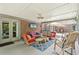 View of the spacious covered patio with ceiling fan, TV, and comfortable rocking chair seating area at 3235 Munsey Ct, Cumming, GA 30041