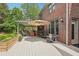Spacious outdoor patio with seating and dining areas, and lush landscaping at 3235 Munsey Ct, Cumming, GA 30041