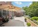 Outdoor patio with dining area, comfortable seating, and luxurious hot tub for relaxation at 3235 Munsey Ct, Cumming, GA 30041