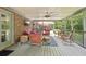 Inviting screened-in patio featuring a ceiling fan, TV, and comfortable seating area at 3235 Munsey Ct, Cumming, GA 30041