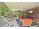 Comfortable screened-in porch featuring cozy seating, ceiling fan, ideal for outdoor enjoyment and relaxation at 3235 Munsey Ct, Cumming, GA 30041