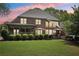 Beautiful brick home with large backyard, covered porch, and hot tub, ideal for outdoor entertaining at 3235 Munsey Ct, Cumming, GA 30041