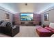 A home theater showcases tiered seating, a large screen, and cozy ambient lighting for an immersive experience at 3235 Munsey Ct, Cumming, GA 30041