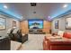 Relax in the tiered seating of this home theater with its projector screen and wood paneled accent wall at 3235 Munsey Ct, Cumming, GA 30041