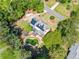 Aerial view of a home with a kidney-shaped pool, lush landscaping, and solar panels at 5247 Hayden Farms Dr, Powder Springs, GA 30127