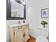 Charming bathroom features a traditional vanity with granite counters, decorative mirror, and lovely decor at 5247 Hayden Farms Dr, Powder Springs, GA 30127