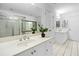 Bright bathroom with a double sink vanity, large mirror, and glass-enclosed shower at 5247 Hayden Farms Dr, Powder Springs, GA 30127