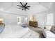 Bright bedroom featuring a tray ceiling, ceiling fan, and neutral decor at 5247 Hayden Farms Dr, Powder Springs, GA 30127