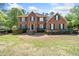 Traditional two-story brick home featuring black shutters and a well-manicured lawn at 5247 Hayden Farms Dr, Powder Springs, GA 30127