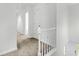 Upstairs hallway featuring carpet, white paint, and access to bedrooms and a staircase at 5247 Hayden Farms Dr, Powder Springs, GA 30127