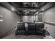 Enjoy movies in this home theater with projector, screen, and comfortable leather seating under a stylish tray ceiling at 5247 Hayden Farms Dr, Powder Springs, GA 30127