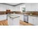 Charming kitchen featuring white cabinets, granite countertops, stainless steel appliances, and hardwood flooring at 5247 Hayden Farms Dr, Powder Springs, GA 30127