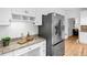 Kitchen featuring granite countertops, a stainless steel refrigerator and a built in desk area at 5247 Hayden Farms Dr, Powder Springs, GA 30127