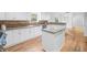 An additional kitchen view with granite countertops, white cabinets, stainless steel appliances and hardwood flooring at 5247 Hayden Farms Dr, Powder Springs, GA 30127