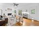 Cozy living room with a fireplace, hardwood floors, neutral decor, and bright light at 5247 Hayden Farms Dr, Powder Springs, GA 30127