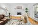 Bright living room with a fireplace, wood floors, and views of the outdoor porch at 5247 Hayden Farms Dr, Powder Springs, GA 30127
