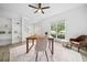 Well-lit office with built-in shelving, hardwood floors, and a large window overlooking the front yard at 5247 Hayden Farms Dr, Powder Springs, GA 30127
