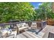 Outdoor deck showcases comfortable seating arrangements, surrounded by lush trees, creating a serene outdoor oasis at 5247 Hayden Farms Dr, Powder Springs, GA 30127